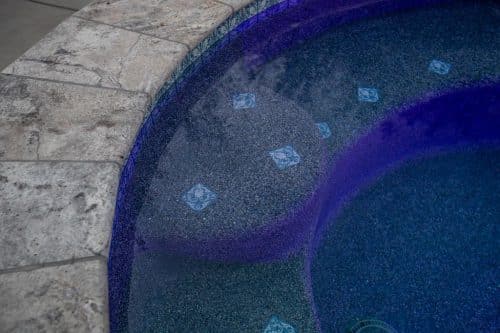 close up on custom tile and purple pool lighting in Orange County luxury swimming pool