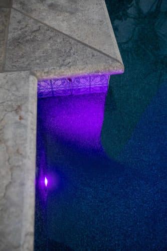 close up of purple underwater swimming pool lights in Orange County pool