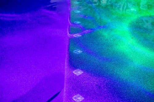 green and purple underwater lights in Orange County residential pool