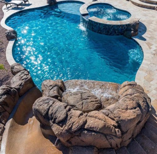 custom-shaped SoCal pool construction with rock features and spa