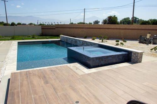 Los Angeles custom swimming pool design with wood poolside flooring