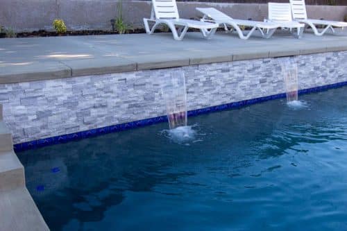 Temecula backyard pool design with bright blue tiling accents