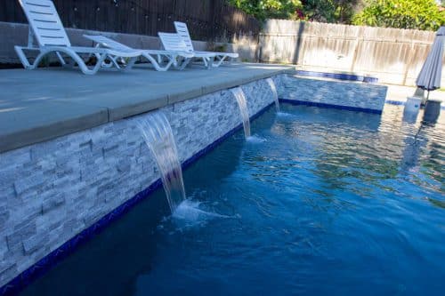 Temecula pool design with bright blue tiling accents