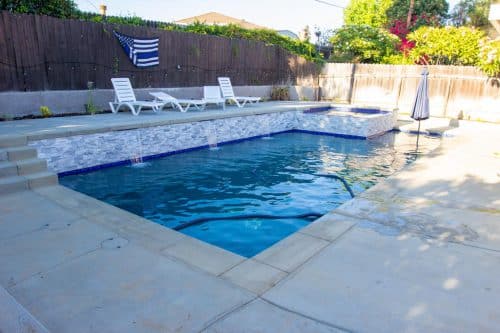 Chino Hills backyard swimming pool design with bright blue tiling accents