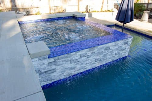 Inland Empire spa design with bright blue tiling