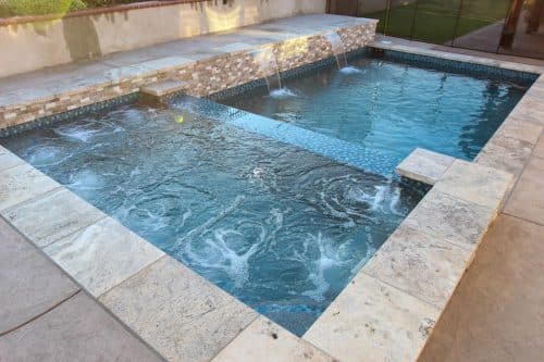 custom backyard pool construction with waterfall features Los Angeles