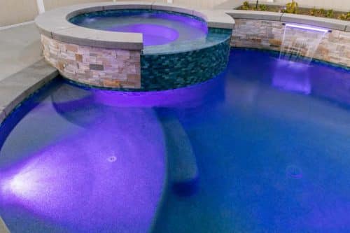 Pool and spa with purple lights