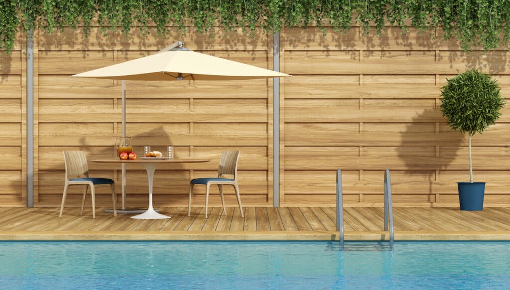 wood paneling surrounding backyard pool design