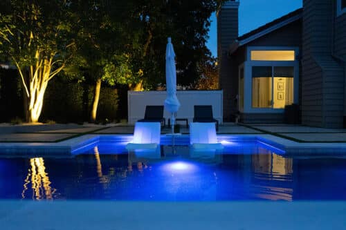 custom backyard pool at night