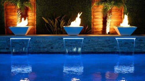 custom backyard pool with fire pits