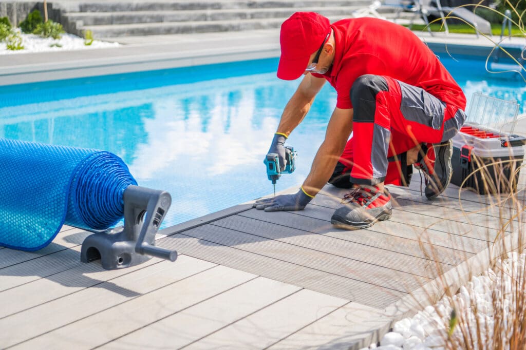 Professional pool worker finishing inground pool installation