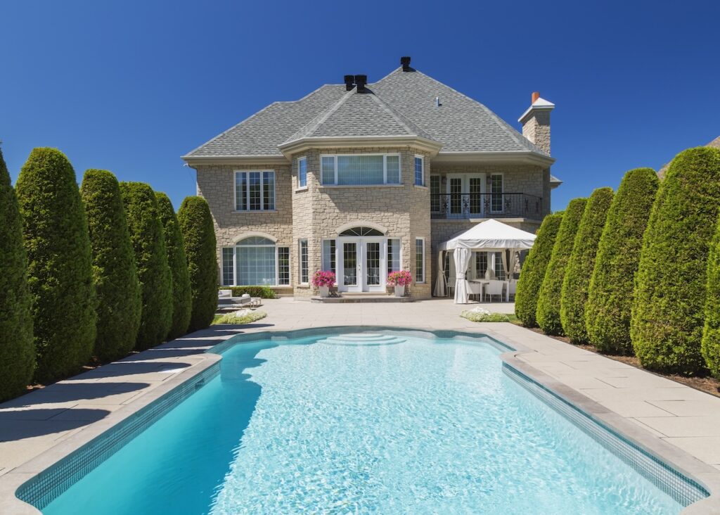 home pool surrounded by cedar trees